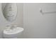 Stylish half bathroom featuring a pedestal sink and decorative mirror at 1723 Fred Ives St, Ruskin, FL 33570