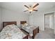 A spacious bedroom featuring carpeted floors, two twin beds, and a ceiling fan at 1723 Fred Ives St, Ruskin, FL 33570