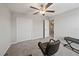A cozy carpeted bedroom with a ceiling fan, closet, and a workstation at 1723 Fred Ives St, Ruskin, FL 33570