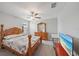 Bright bedroom featuring a ceiling fan, a large wooden bed frame, and plenty of natural light at 1723 Fred Ives St, Ruskin, FL 33570