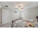 A room featuring carpeted floors, two twin beds, a ceiling fan, and plenty of natural light at 1723 Fred Ives St, Ruskin, FL 33570