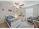 Relaxing bedroom featuring carpeted floors, a ceiling fan, a dresser, and a comfortable bed at 1723 Fred Ives St, Ruskin, FL 33570