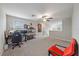 Bright bonus room with neutral carpet, ceiling fan and window for natural light, perfect for a study or playroom at 1723 Fred Ives St, Ruskin, FL 33570