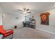 Open bonus room featuring carpeted floors, ceiling fan, creating a versatile living area for various activities at 1723 Fred Ives St, Ruskin, FL 33570