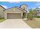 Charming single-Gathering home featuring a two-car garage, a well-manicured lawn, and lush landscaping at 1723 Fred Ives St, Ruskin, FL 33570