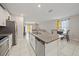 Open concept kitchen features an island with seating, stainless steel appliances, and a seamless flow to living spaces at 1723 Fred Ives St, Ruskin, FL 33570