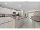 Bright kitchen featuring a center island with granite countertops, white cabinetry, and stainless steel appliances at 1723 Fred Ives St, Ruskin, FL 33570