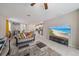 Inviting living room boasts neutral tones, tile flooring, and flows seamlessly into the kitchen and dining area at 1723 Fred Ives St, Ruskin, FL 33570
