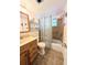 Bathroom featuring a single sink vanity, toilet, and shower with brown tile surround and a curtain at 1819 Restful Dr # N25, Bradenton, FL 34207