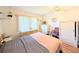 Bedroom featuring hardwood floors, ceiling fan, window with blinds, and two dressers at 1819 Restful Dr # N25, Bradenton, FL 34207