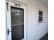 Condominium doorway featuring the unit number and exterior window at 1819 Restful Dr # N25, Bradenton, FL 34207