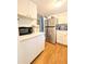 Galley kitchen with stainless steel refrigerator and white appliances and cabinetry at 1819 Restful Dr # N25, Bradenton, FL 34207