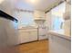 Galley kitchen with stainless steel refrigerator and white appliances and cabinetry at 1819 Restful Dr # N25, Bradenton, FL 34207