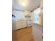 Galley kitchen with stainless steel refrigerator and white appliances and cabinetry at 1819 Restful Dr # N25, Bradenton, FL 34207