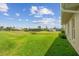 Expansive backyard with lush green lawn and a view of the water in a peaceful neighborhood setting at 1836 Ironwood Ct, Venice, FL 34293
