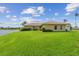 Landscaped backyard with green lawn and view of the lake at 1836 Ironwood Ct, Venice, FL 34293