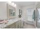 Bright bathroom with a granite vanity, large mirror, and a tiled walk-in shower at 1836 Ironwood Ct, Venice, FL 34293
