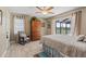 Cozy bedroom with a rocking chair, wood-look floors, and access to a screened-in porch at 1836 Ironwood Ct, Venice, FL 34293