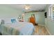 Relaxing bedroom with nautical decor, ceiling fan, and wood-look floors at 1836 Ironwood Ct, Venice, FL 34293