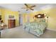 Bright bedroom boasts tiled floors, a ceiling fan, and calming yellow walls at 1836 Ironwood Ct, Venice, FL 34293