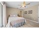 Neutral bedroom features wood floors, ceiling fan, queen-size bed, and decor at 1836 Ironwood Ct, Venice, FL 34293