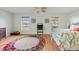 Bright bedroom with wood floors, rug, ceiling fan and two large windows at 1836 Ironwood Ct, Venice, FL 34293