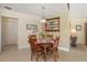 Cozy dining room with wood table and chairs adjacent to kitchen and living areas at 1836 Ironwood Ct, Venice, FL 34293