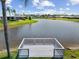 Charming private dock sitting on a scenic lake, perfect for relaxing and enjoying waterfront views at 1836 Ironwood Ct, Venice, FL 34293