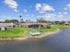 Beautiful home with screened pool, private dock on the lake, and lush landscaping for outdoor enjoyment at 1836 Ironwood Ct, Venice, FL 34293
