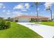 Exterior of home featuring a tile roof, lawn and a two-car garage at 1836 Ironwood Ct, Venice, FL 34293