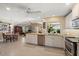 Open kitchen with large window, stainless appliances and granite countertops at 1836 Ironwood Ct, Venice, FL 34293