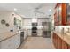 Bright kitchen features white cabinets, granite countertops, and stainless steel appliances at 1836 Ironwood Ct, Venice, FL 34293