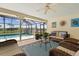 Screened patio featuring comfortable seating and views of the pool and lake at 1836 Ironwood Ct, Venice, FL 34293