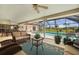 Relaxing outdoor lanai featuring pool view, comfortable seating and ceiling fan at 1836 Ironwood Ct, Venice, FL 34293