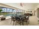 Enclosed patio featuring a dining table overlooking the pool and waterfront views at 1836 Ironwood Ct, Venice, FL 34293