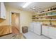 Bright laundry room with modern washer/dryer, storage, and utility sink at 1836 Ironwood Ct, Venice, FL 34293