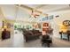 Spacious living room with tile flooring, vaulted ceiling, and sliding glass doors at 1836 Ironwood Ct, Venice, FL 34293
