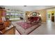 Sunlit living room features comfortable seating, tile flooring, and a view of the pool and patio at 1836 Ironwood Ct, Venice, FL 34293