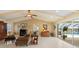 Inviting living room with pool view, fireplace, and vaulted ceilings at 1836 Ironwood Ct, Venice, FL 34293
