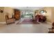 Bright living room features neutral tile flooring, comfortable seating, and a view of the screened patio and pool at 1836 Ironwood Ct, Venice, FL 34293