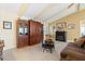Comfortable living room with fireplace, wood cabinetry, and tile flooring at 1836 Ironwood Ct, Venice, FL 34293