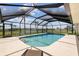 Screen enclosed pool with spa and comfortable lounge chair at 1836 Ironwood Ct, Venice, FL 34293
