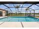 Enclosed screened pool with attached spa and beautiful backyard lake view at 1836 Ironwood Ct, Venice, FL 34293