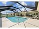 Large screened in pool with an attached patio area and waterfront view at 1836 Ironwood Ct, Venice, FL 34293