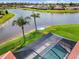 A beautiful screened pool overlooking the lake and private dock, creating a serene and private retreat at 1836 Ironwood Ct, Venice, FL 34293