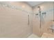 Walk-in shower boasts neutral tile, pebbled floor, and built-in shelves at 1836 Ironwood Ct, Venice, FL 34293