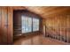 Wood-paneled attic featuring built-in shelves, a staircase, and natural light at 1931 Bahia Vista St, Sarasota, FL 34239