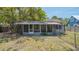Exterior view of home's screened-in porch with a fenced yard at 1931 Bahia Vista St, Sarasota, FL 34239