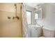 Bathroom featuring a shower, toilet, sink, medicine cabinet, and neutral tile at 1931 Bahia Vista St, Sarasota, FL 34239