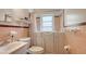 Bathroom featuring a walk-in bathtub, toilet, sink, and neutral tile at 1931 Bahia Vista St, Sarasota, FL 34239